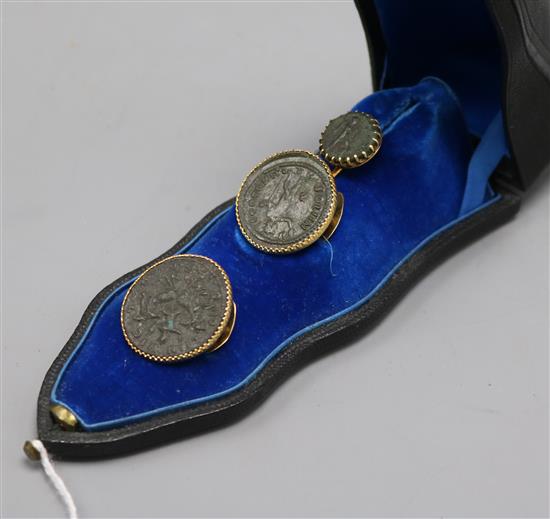 Three Roman coins, yellow metal mounted as a tie pin and button set, in French fitted box.